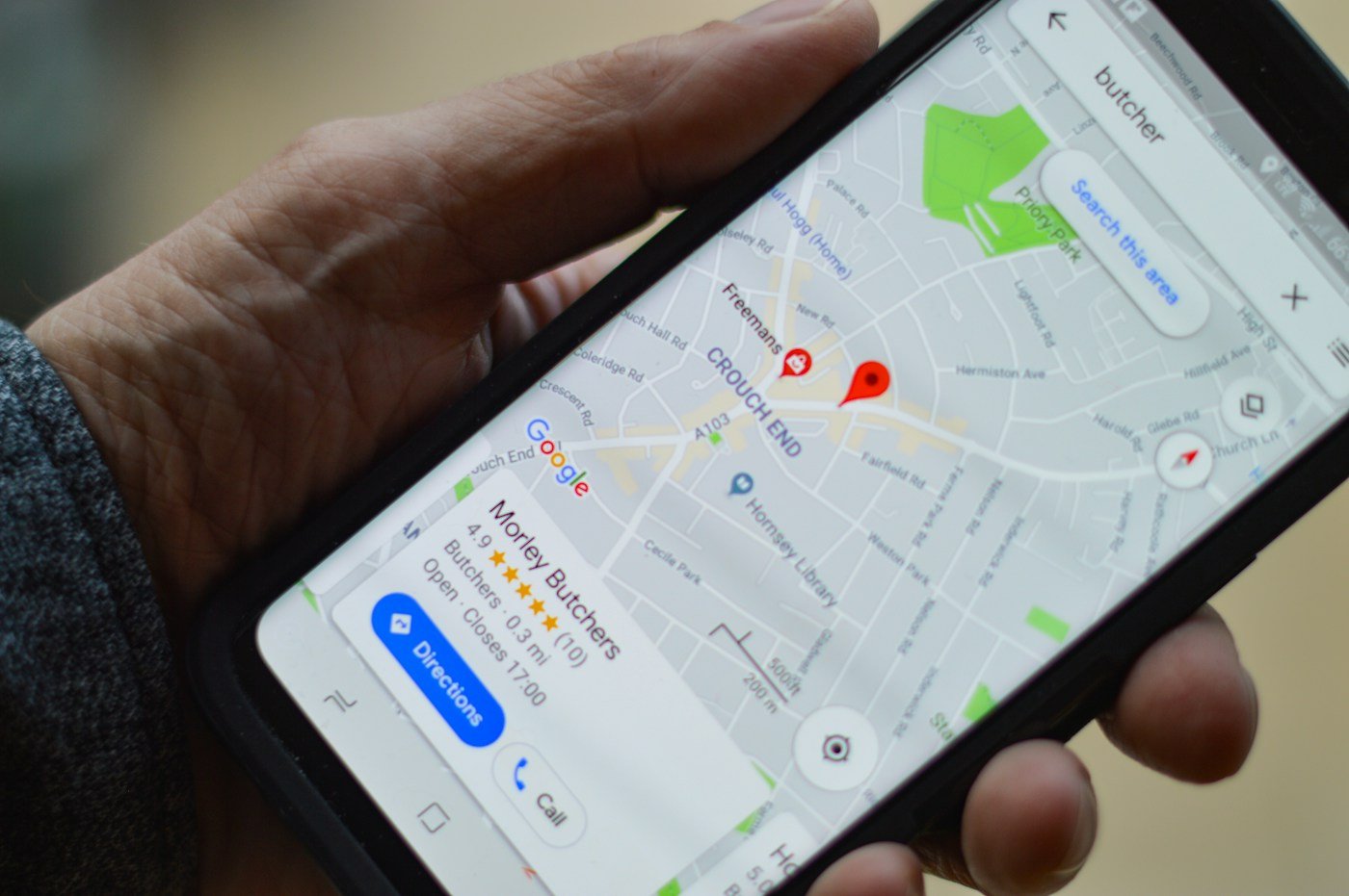 Smartphone displaying a local map search representing Google Business Profile and local visibility